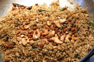 Cashews and peanuts added to tamarind rice.