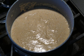 Amaranth flour roasting in ghee in a pot.
