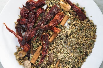 Dry spices in a white plate for tandoori masala.