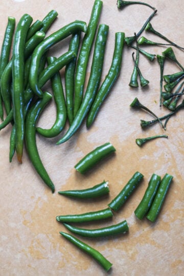 Green chilies with tops cut off and chopped into pieces.