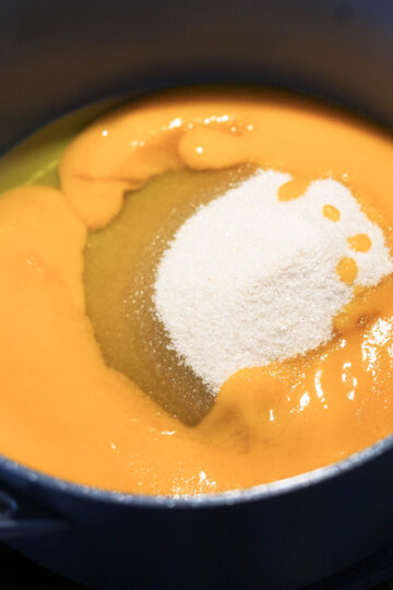 Mango pulp and sugar added to pan.