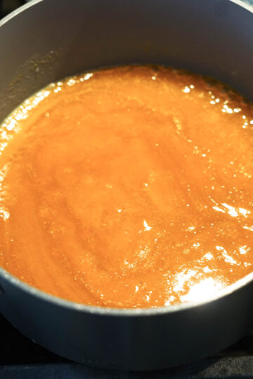 Mango mixture simmering in a pot.