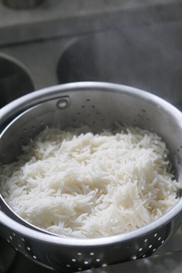 Cooked basmati rice in a colander.