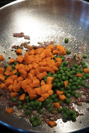 Carrots and peas added to pan.