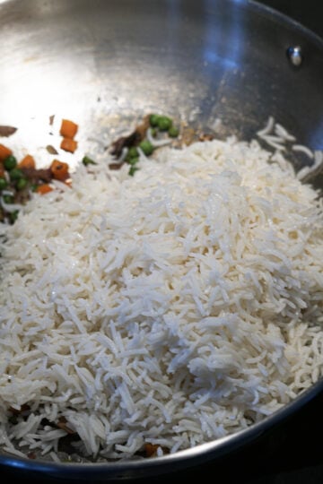 Cooked Basmati rice aded to pan.