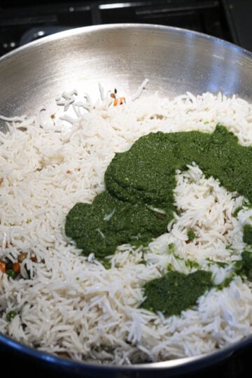 Add mint paste to basmati rice in pan.