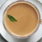 Indian mint tea in a mug with a mint leaf garnish.