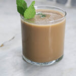 Philz mint mojito coffee in a glass with a mint garnish.