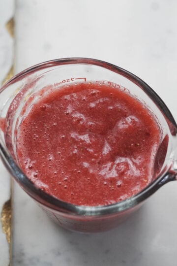 Strawberry puree in a measuring cup.