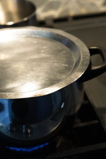 A covered pot on the stove.