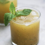 Glass of aam panna with a mint spring garnish.