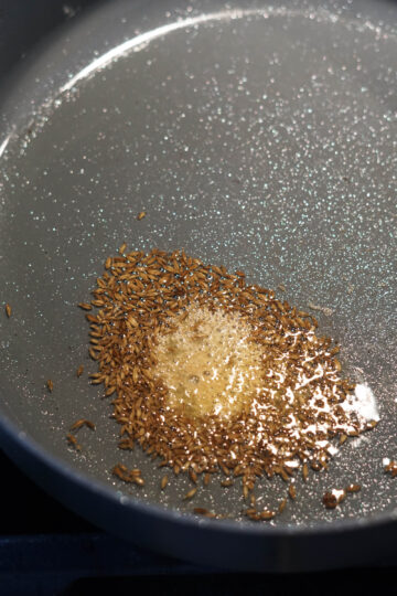 Cumin seed tadka with asafoetida in oil.