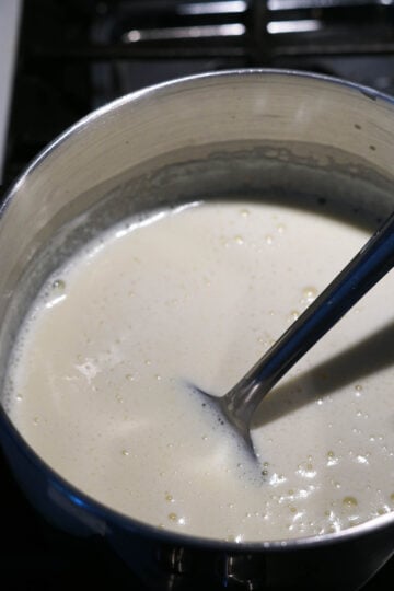 Stirring a pot of custard milk mixture.