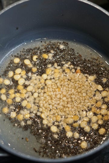 Chana dal and urad dal added to tadka.