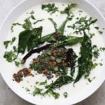 Curd rice topped with a tadka of curry leaves, dals, spices and cilantro leaves.