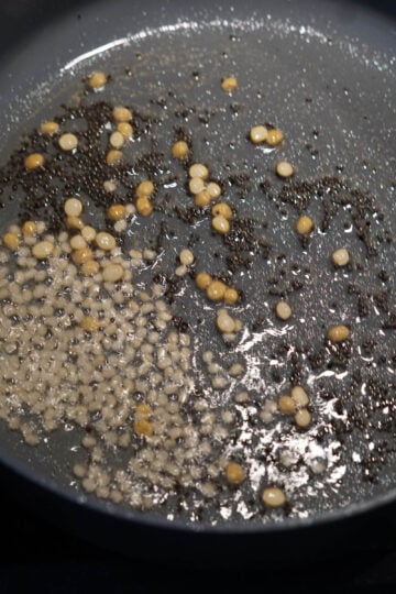 Urad dal and chana dal added to pan.