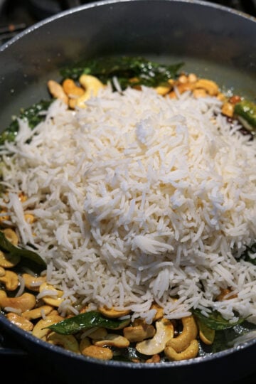 Cooked basmati rice added to pan.