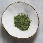 Kasuri methi in a gold rimmed bowl.