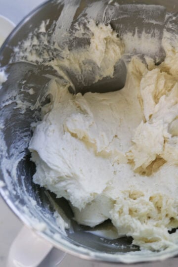Cream cheese and sugar in a mixer bowl.