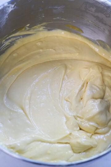 Mango cheesecake batter in a mixing bowl.