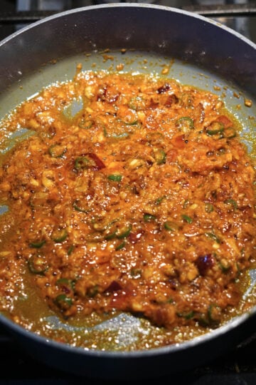 Onion tomato garlic paste in a pan.