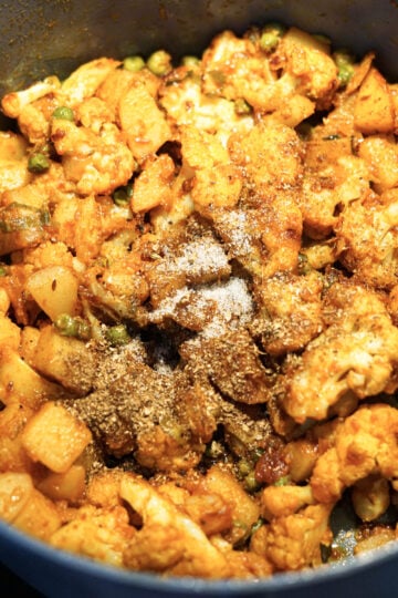 Garam masala and sugar added to the pot.