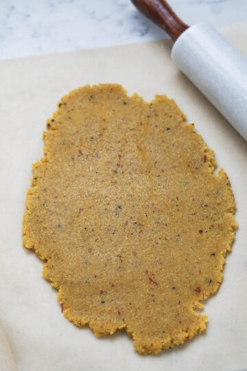 Rolled out dough with a rolling pin to the side.