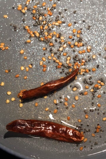 Dried red chilies added to pan.