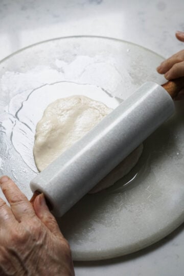 Rolling out a parotta.