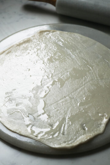 Thin rolled out dough ball.