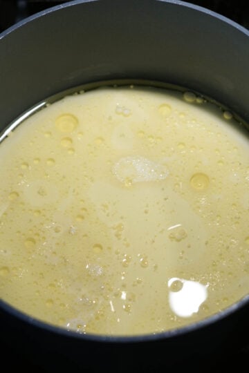 Melted ghee with milk in a pot.