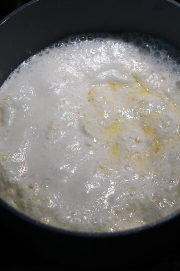 Simmering ghee, milk, and lemon juice.