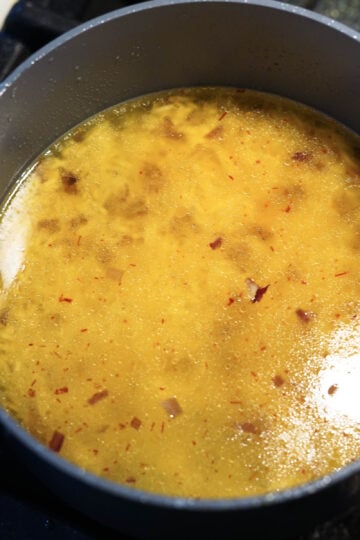 Saffron water in a pot with basmati rice.