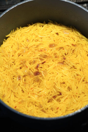 Cooked yellow rice in a pot.