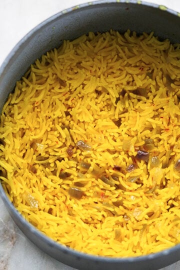 Saffron rice grains turned up in pot.