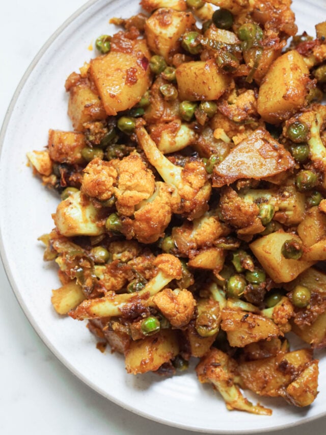 Aloo gobi matar in a white plate.