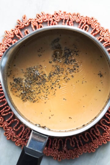 Boiled masala chai in a steel pot.