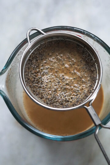 Sieve over a measuring cup.