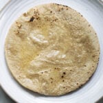 Gluten free jowar roti on a plate with ghee.