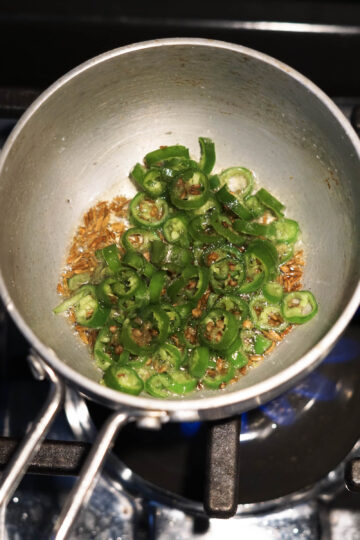 Tadka pan with cumin seeds, ghee, and green chilies.