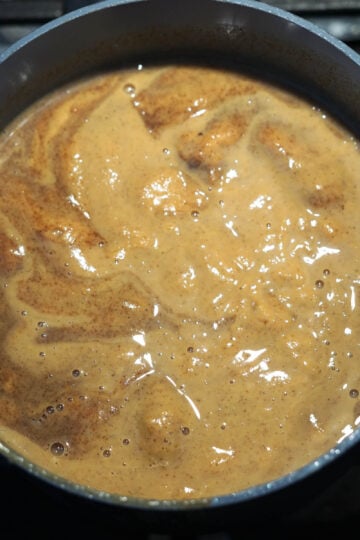 Simmering pumpkin sauce in a pot.