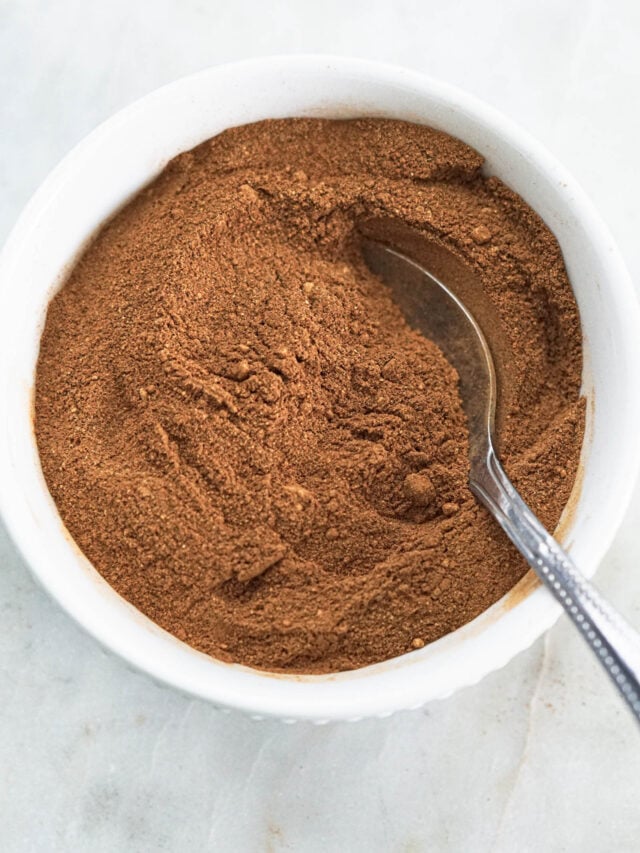 Pumpkin pie spice in a bowl with a spoon.