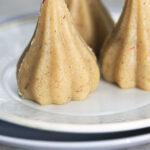 Almond modaks on a plate.