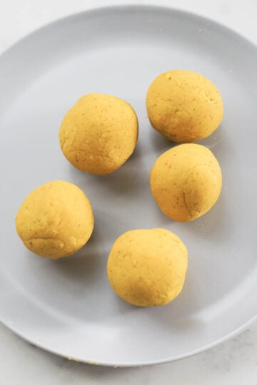 Five besan flour dough balls.