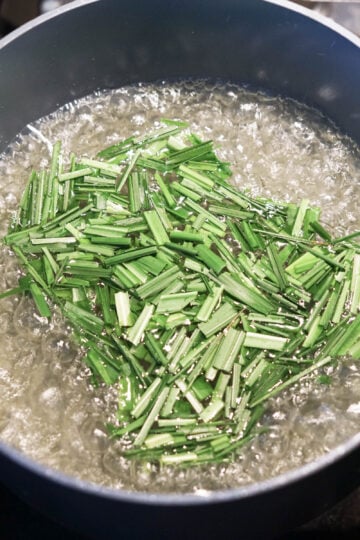 Lemongrass pieces boiling in water.
