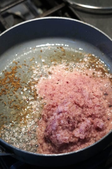 Ginger, garlic, onion paste added to pan.