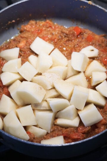 Potatoes, sugar in a pan with onion, ginger, garlic base.