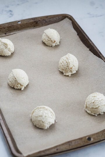 Cookie scoop on a cookie sheet.