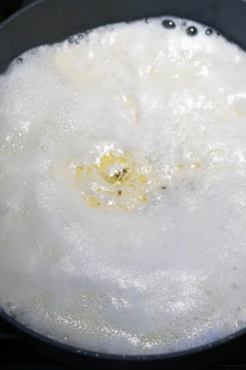Lemon juice, milk, and ghee in a pan.
