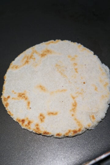 Almond flour roti with brown marks.